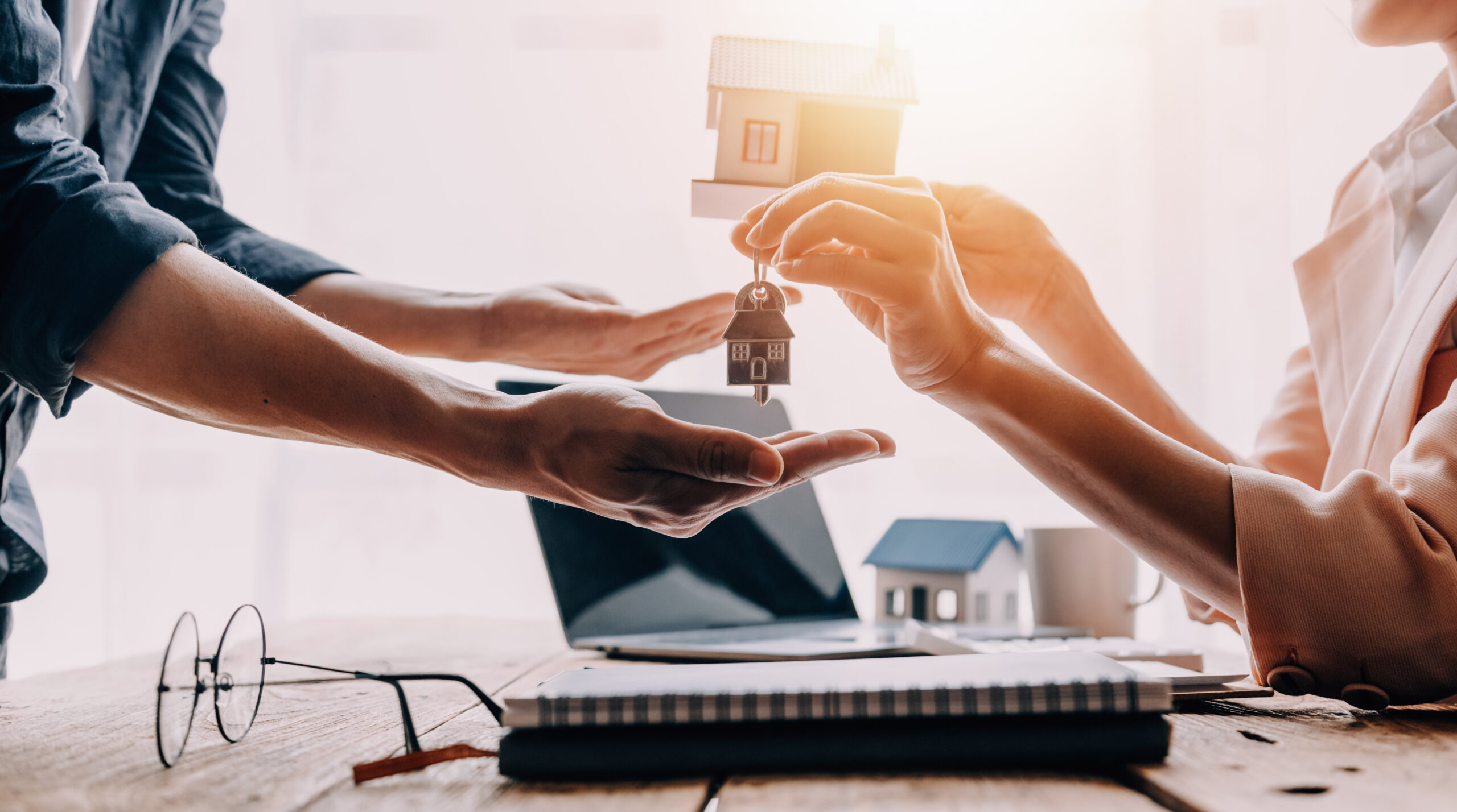 Real estate broker agent presenting and consult to customer to decision making sign insurance form agreement, buy and sell home model, concerning mortgage loan offer for and house insurance